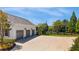 Three car garage and expansive driveway for ample parking featuring an outdoor basketball court at 210 Tifton Ln, Roswell, GA 30075