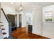 Entryway with wood floors, staircase, custom coat rack, and decorative lighting fixtures at 210 Tifton Ln, Roswell, GA 30075