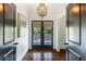 Hallway featuring dark hardwood floors, french doors to backyard, and decorative lighting at 210 Tifton Ln, Roswell, GA 30075