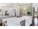 Spacious kitchen with island, modern lighting, stainless appliances, and open floor plan at 210 Tifton Ln, Roswell, GA 30075