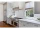 Gourmet kitchen with stainless steel appliances, quartz countertops, and ample natural light at 210 Tifton Ln, Roswell, GA 30075