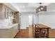 A charming kitchenette features a wooden island with seating, stainless steel appliances, and white plank walls at 210 Tifton Ln, Roswell, GA 30075