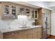 This kitchenette features stainless steel refrigerator, stone countertops, tile backsplash, and ample cabinet space at 210 Tifton Ln, Roswell, GA 30075