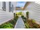 Charming walkway between homes with lush landscaping featuring a variety of plants at 210 Tifton Ln, Roswell, GA 30075