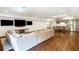 Spacious living room features hardwood floors, multiple TVs, and a cozy sofa, perfect for entertaining at 210 Tifton Ln, Roswell, GA 30075