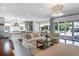 Bright open-concept living room with hardwood floors and seamless access to the outdoor pool at 210 Tifton Ln, Roswell, GA 30075