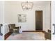 Stylish office space with paneled walls, hardwood floors, an elegant chandelier, and muted artwork at 210 Tifton Ln, Roswell, GA 30075