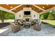 An outdoor kitchen featuring an entertainment area with a fireplace and comfortable seating at 210 Tifton Ln, Roswell, GA 30075