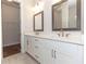 Bathroom with a double vanity, framed mirrors, and a walk-in closet at 2381 Siskin Square Rd, Duluth, GA 30096