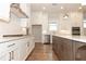 Contemporary kitchen with stainless steel appliances, an island, and white cabinets at 2381 Siskin Square Rd, Duluth, GA 30096