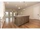 Open concept kitchen boasts an island, stainless steel appliances, and hardwood floors at 2381 Siskin Square Rd, Duluth, GA 30096