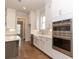 Bright kitchen features stainless steel oven, white cabinets, and tiled backsplash at 2381 Siskin Square Rd, Duluth, GA 30096