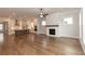 Open concept living space featuring hardwood floors, fireplace, and kitchen at 2381 Siskin Square Rd, Duluth, GA 30096