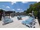 A full view of the community pool featuring lounge seating, tables, and umbrellas at 2381 Siskin Square Rd, Duluth, GA 30096