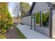 Backyard view featuring a concrete patio, lush greenery, and large windows at 2710 Sandy Irwin Sw Ct, Marietta, GA 30064