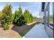 Landscaped backyard featuring a concrete patio, mulch beds, and privacy trees at 2710 Sandy Irwin Sw Ct, Marietta, GA 30064