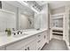 Modern bathroom featuring double sinks, white cabinets, sleek fixtures, and a glass-enclosed shower at 2710 Sandy Irwin Sw Ct, Marietta, GA 30064