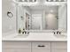 Clean bathroom design with a white vanity, double sinks, large mirror, and modern black fixtures at 2710 Sandy Irwin Sw Ct, Marietta, GA 30064
