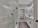 Modern bathroom with a glass enclosed shower, double sinks, and access to the walk-in closet at 2710 Sandy Irwin Sw Ct, Marietta, GA 30064