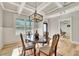 Cozy dining room features a coffered ceiling, a stylish light fixture, and light-filled windows at 2710 Sandy Irwin Sw Ct, Marietta, GA 30064