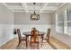 Inviting dining room features hardwood floors, a coffered ceiling, and a decorative light fixture at 2710 Sandy Irwin Sw Ct, Marietta, GA 30064