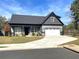 Charming two-story home showcasing a well-manicured lawn and a spacious two-car garage at 2710 Sandy Irwin Sw Ct, Marietta, GA 30064