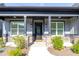 Inviting front porch with stone pillars and stylish black door and fixtures at 2710 Sandy Irwin Sw Ct, Marietta, GA 30064