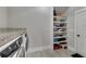 Well-organized laundry room with washer, dryer, storage shelves and tiled flooring at 2710 Sandy Irwin Sw Ct, Marietta, GA 30064