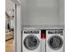 Convenient laundry room featuring side-by-side washer and dryer with granite countertops at 2710 Sandy Irwin Sw Ct, Marietta, GA 30064