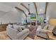 Spacious living room features exposed beams, a stone fireplace, and plenty of natural light at 2710 Sandy Irwin Sw Ct, Marietta, GA 30064