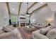 Bright living room with wood beam ceilings, stone fireplace, plush seating and a decorative rug at 2710 Sandy Irwin Sw Ct, Marietta, GA 30064