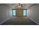 Spacious bedroom with neutral walls, plush carpeting, ceiling fan and abundant natural light from two windows at 3104 Leyland Ct, Decatur, GA 30034