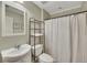 Cozy bathroom featuring a white sink, toilet, and a shower with a white curtain at 313 Red Fox Dr, Canton, GA 30114