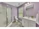 Bathroom featuring a shower, vanity, toilet, and window for natural light at 313 Red Fox Dr, Canton, GA 30114