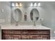 Bathroom featuring double sinks, wood cabinets, and large vanity mirrors at 313 Red Fox Dr, Canton, GA 30114