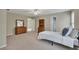 Carpeted bedroom with bed, furniture, and doorways leading to other rooms at 313 Red Fox Dr, Canton, GA 30114