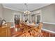 Spacious dining room with hardwood floors, stylish chandelier, and open access to other living areas at 313 Red Fox Dr, Canton, GA 30114