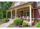Charming front porch with rocking chairs and manicured landscaping for relaxing and curb appeal at 313 Red Fox Dr, Canton, GA 30114