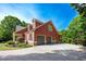 Stylish red two-story home with an attached two-car garage and a long concrete driveway at 313 Red Fox Dr, Canton, GA 30114