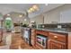 Open kitchen featuring wood floors, wood cabinets, and stainless-steel appliances at 313 Red Fox Dr, Canton, GA 30114