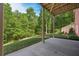 Covered patio overlooking a lush green backyard surrounded by mature trees at 313 Red Fox Dr, Canton, GA 30114