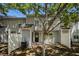 View of the backyard area with a black door entrance framed by a mature shade tree at 3149 Kingswood Gln, Decatur, GA 30034