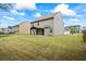 View of the backyard with a covered patio and green grass at 3573 Stonebranch Ln, Loganville, GA 30052