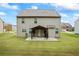 Large backyard with a covered patio area, grassy lawn, and privacy fencing at 3573 Stonebranch Ln, Loganville, GA 30052