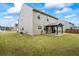Spacious backyard featuring a covered patio, grassy area, and privacy fence at 3573 Stonebranch Ln, Loganville, GA 30052