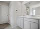 Bathroom featuring double sink vanity, gray cabinets, and tile flooring, plus a door to a water closet at 3573 Stonebranch Ln, Loganville, GA 30052
