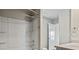 Bathroom featuring a white tub with shower and grab bar, and door to another room at 3573 Stonebranch Ln, Loganville, GA 30052