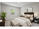 Bedroom featuring a bed, bench, two side tables, a window, and carpeted floors at 3573 Stonebranch Ln, Loganville, GA 30052