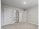 An empty bedroom showcases neutral walls, plush carpeting, and multiple white doors at 3573 Stonebranch Ln, Loganville, GA 30052