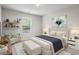 Bedroom showcasing a bed, bench, side chair, decorative shelving, and large window at 3573 Stonebranch Ln, Loganville, GA 30052